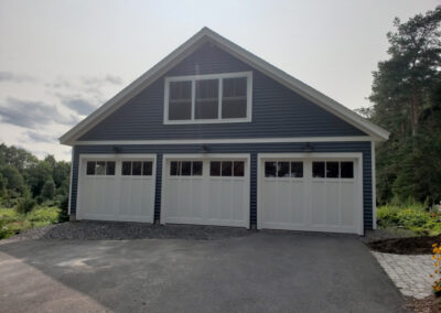 three car garage with white doors